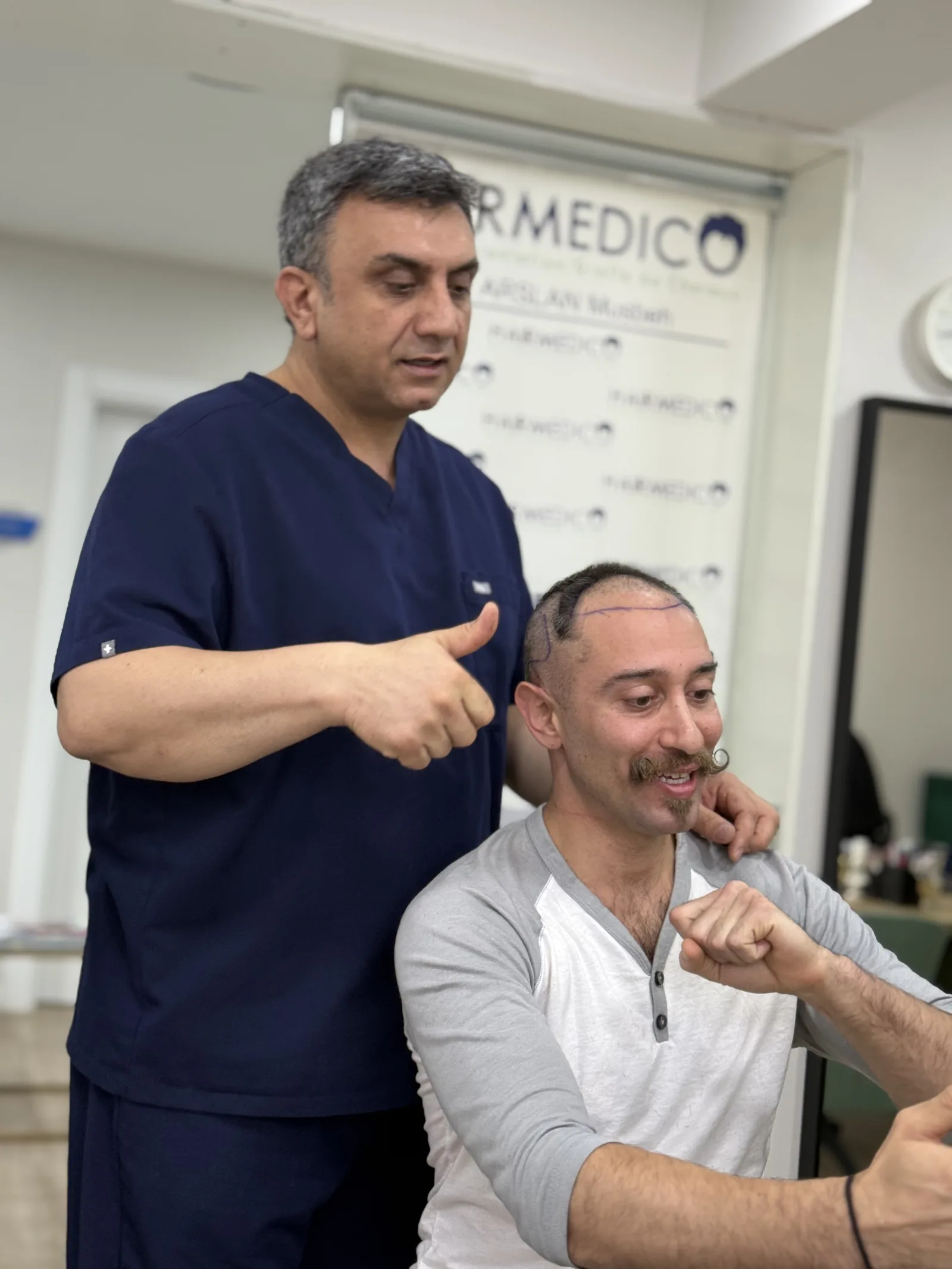Dr. Arslan Musbeh with a patient whose hairline has just been marked, at a Hairmedico consultation