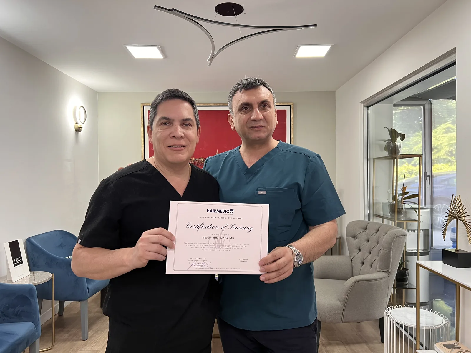 Dr Arslan Musbeh presenting a Hairmedico Certification of Training in the FUE method to visiting surgeon Dr Henry Mata