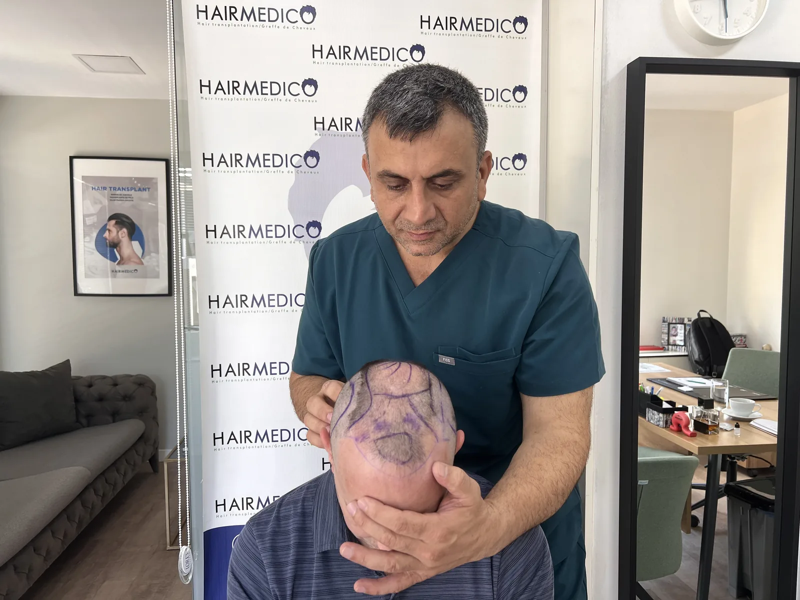 Dr. Arslan Musbeh drawing a hairline design on a patient at the Hairmedico Istanbul office
