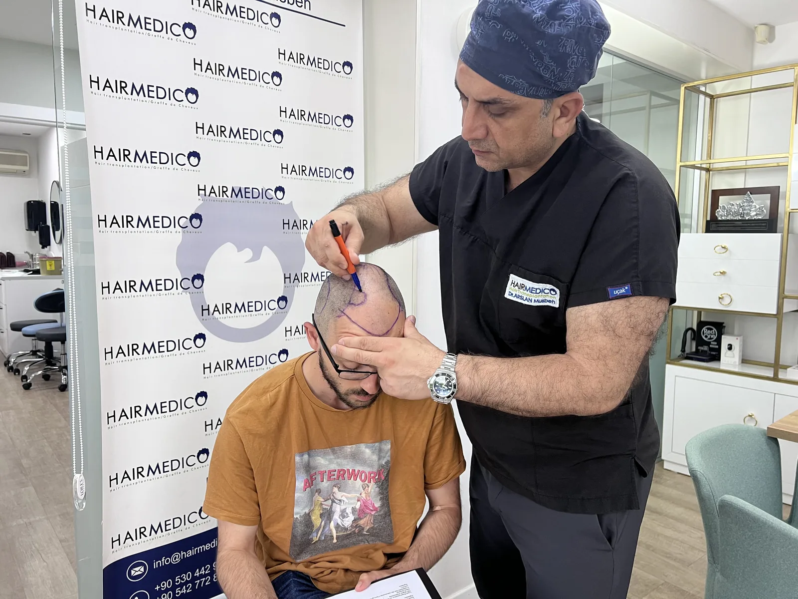 Dr. Arslan Musbeh personally marking a patient's hairline design before restoration surgery at Hairmedico