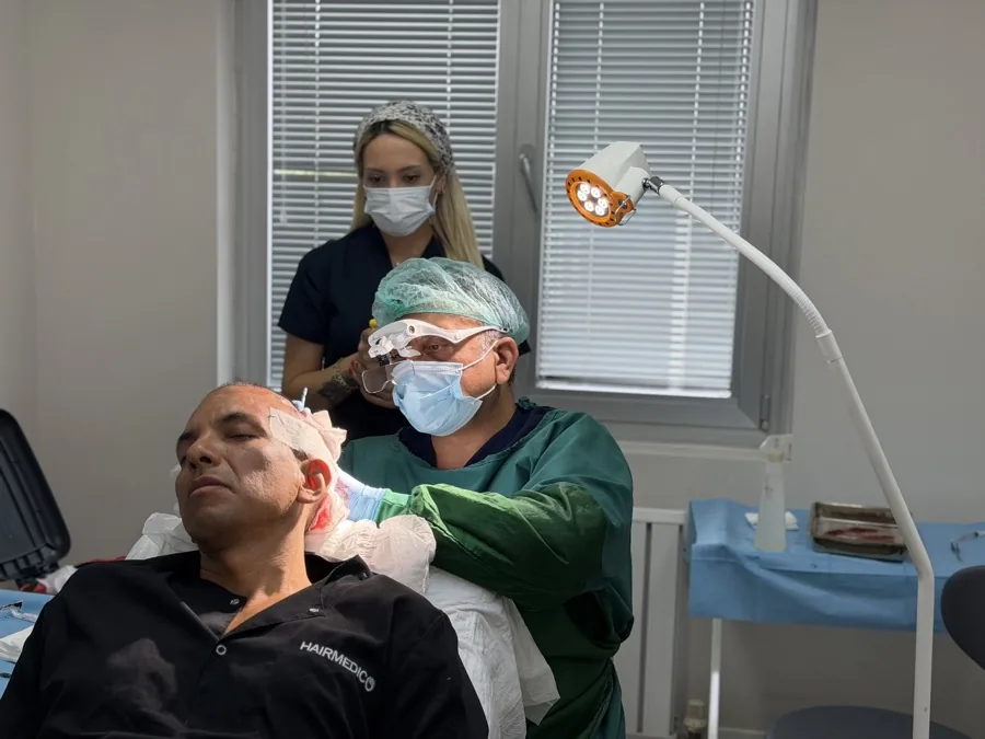 Dr. Arslan Musbeh personally assessing a patient's donor area during a hair transplant procedure at Hairmedico