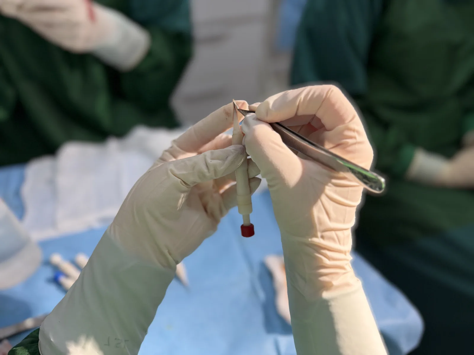 Surgical team handling instruments with precision during a hair transplant procedure at Hairmedico Istanbul