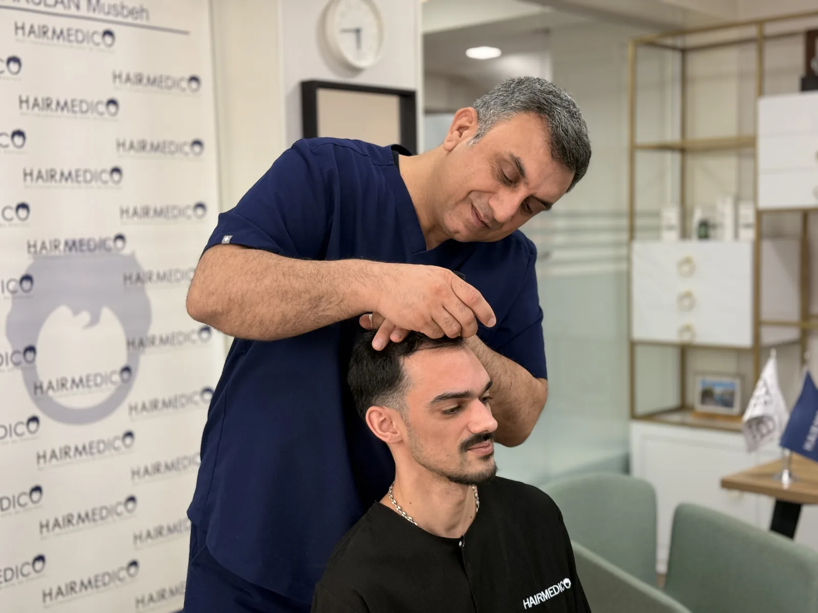 Dr. Arslan Musbeh reviewing a patient's finished hair result in person at the Hairmedico clinic
