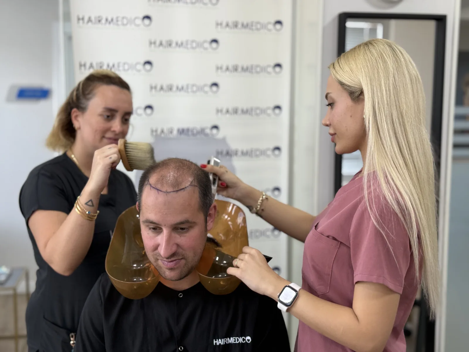 Hairmedico clinical staff preparing a patient's scalp before a treatment session, Istanbul clinic