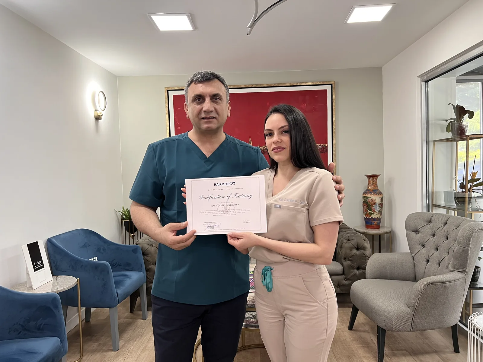 Dr. Arslan presenting a Hairmedico FUE-method certification of training to a clinic technician