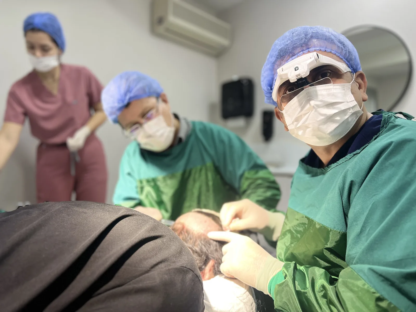 Dr. Arslan Musbeh and the surgical team performing hair transplant extraction at Hairmedico Istanbul