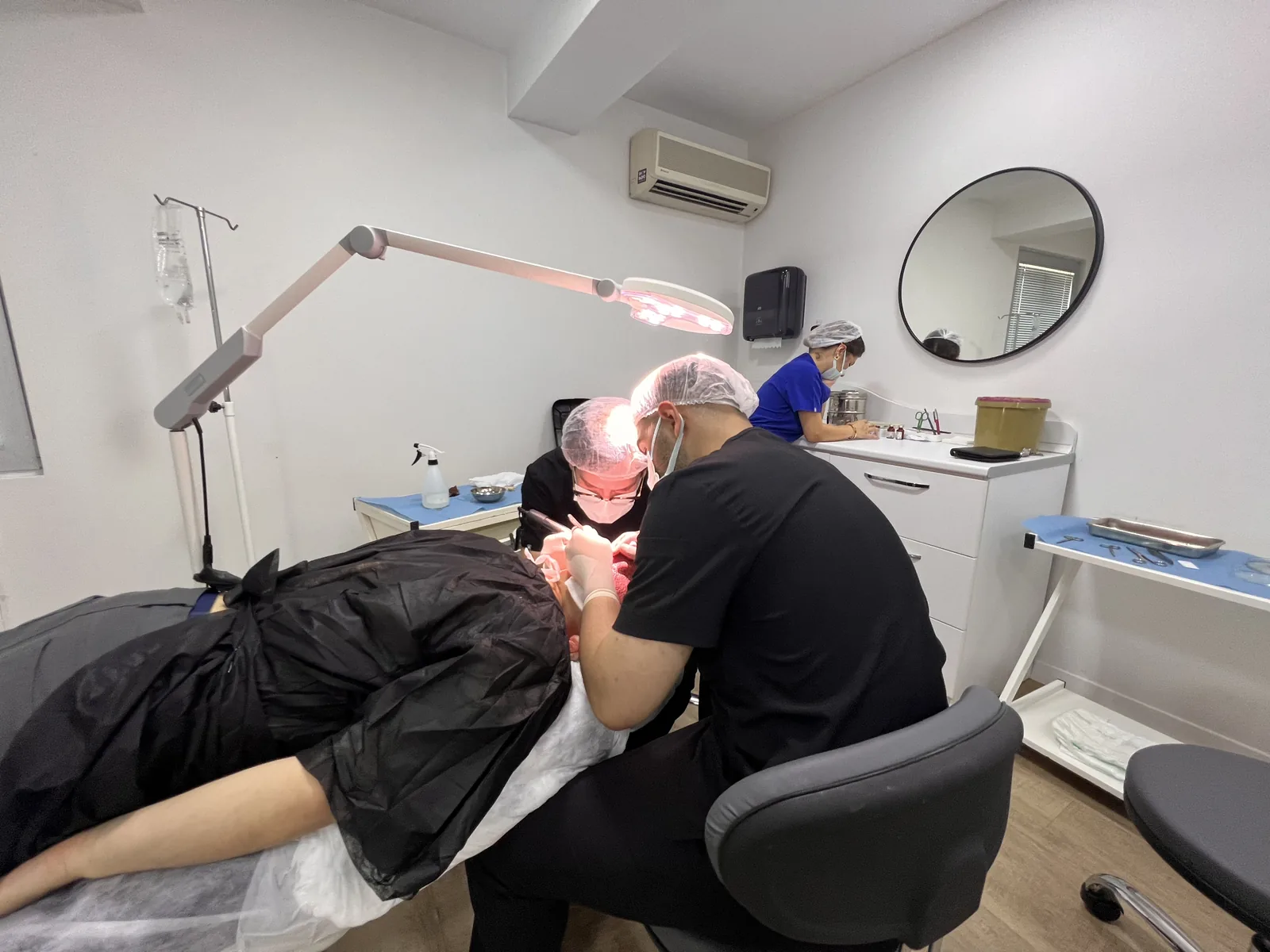 Dr. Arslan's surgical team performing a hair transplant procedure in the Hairmedico operating room